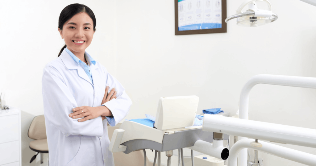 dentist posing in a room full of dental equipment