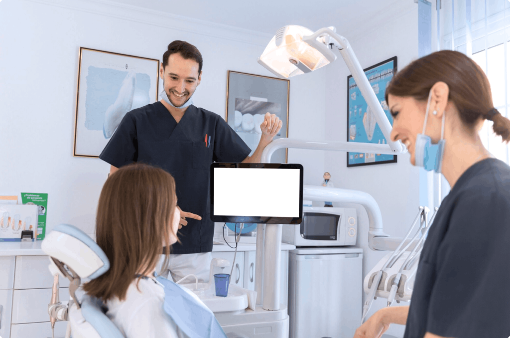 patient in treatment room with two dentist
