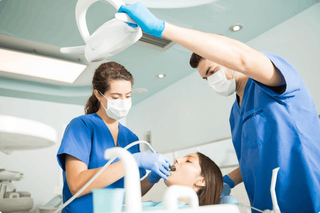dentist and her assistant treating a patient