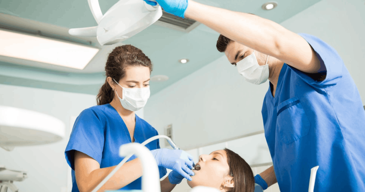 dentist and her assistant treating a patient